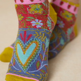 Colorful socks with floral and heart patterns on a beige background