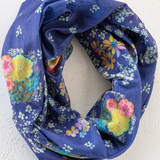 Navy blue floral patterned infinity scarf on a white background
