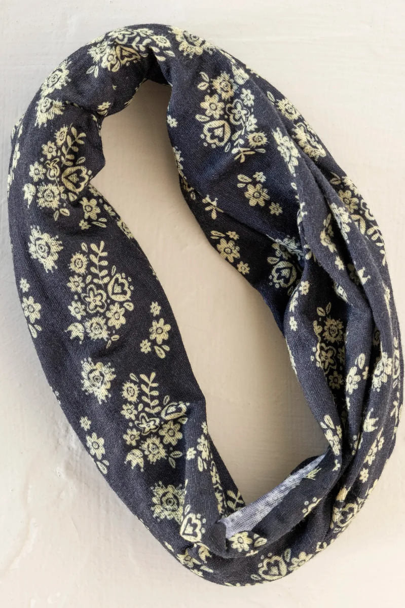 Black infinity scarf with yellow floral pattern on a white background