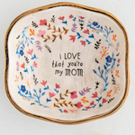 Decorative plate with floral design and text on a white background