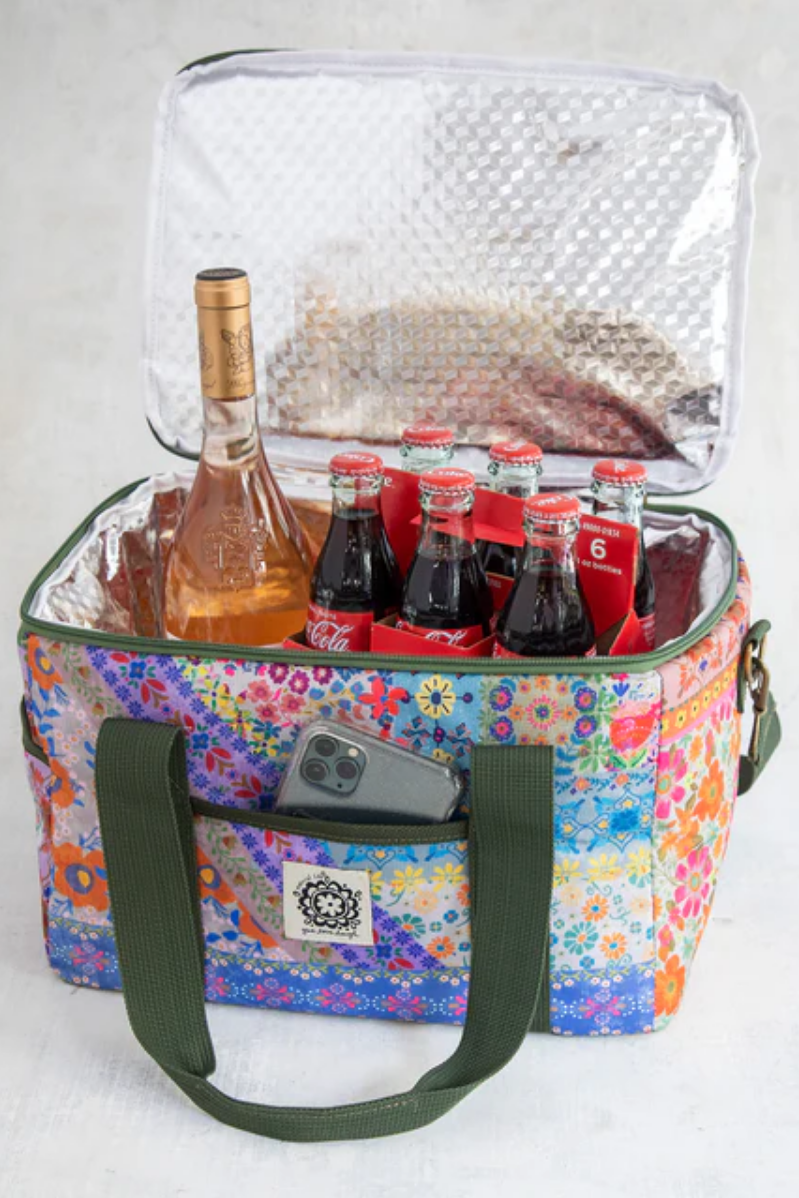 Colorful floral-patterned cooler bag with bottles and a phone inside on a white background