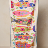 Colorful fish-patterned bag on a beige background