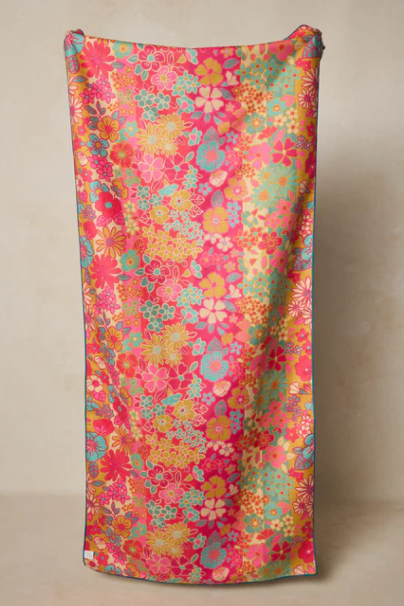 Colorful floral patterned fabric on a beige background