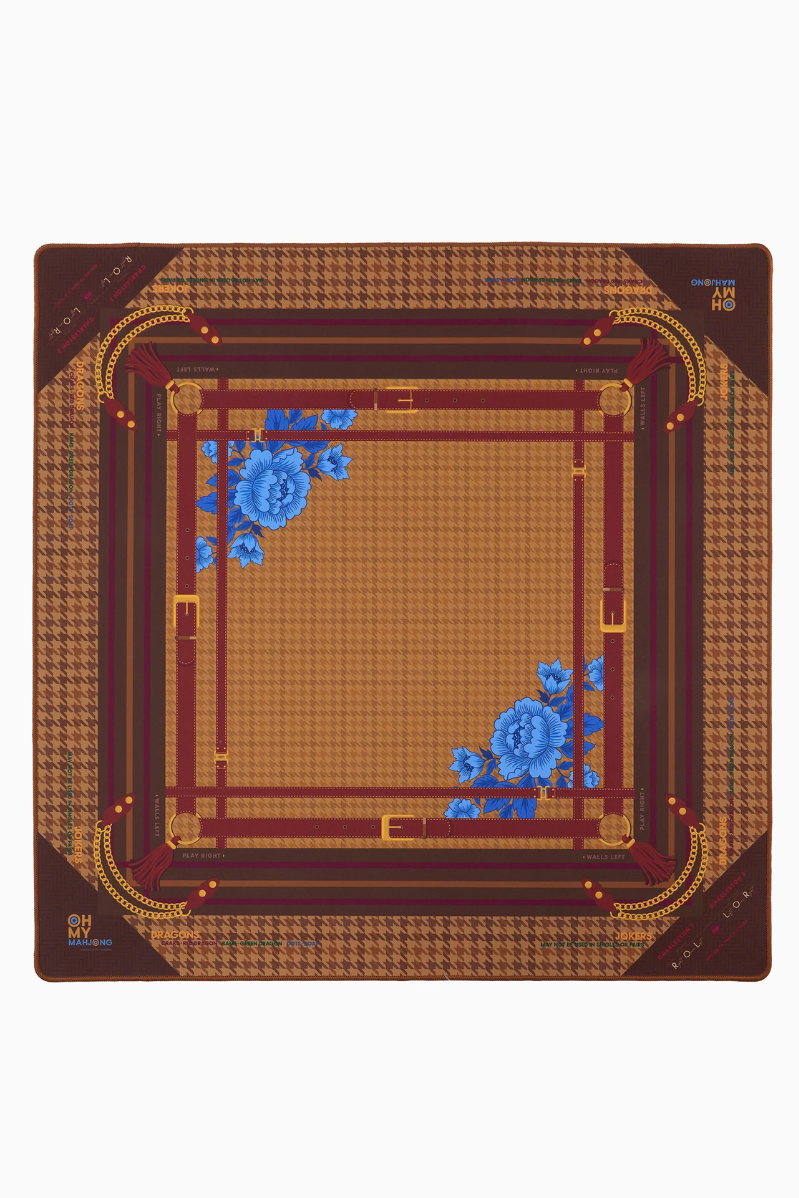 Decorative Mahjong mat with floral patterns, houndstooth and gold accents on a white background. Palomino Mat in Tube | Oh My Mahjong