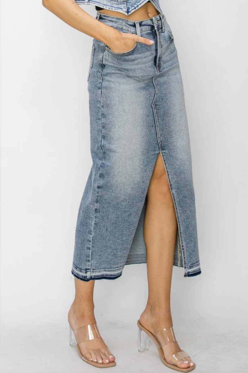 Denim skirt with a high slit worn by a person on a white background