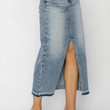 Denim skirt with a high slit worn by a person on a white background