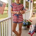 Woman standing on porch wearing Americana Striped Relaxed Fit Top with matching bottoms. 