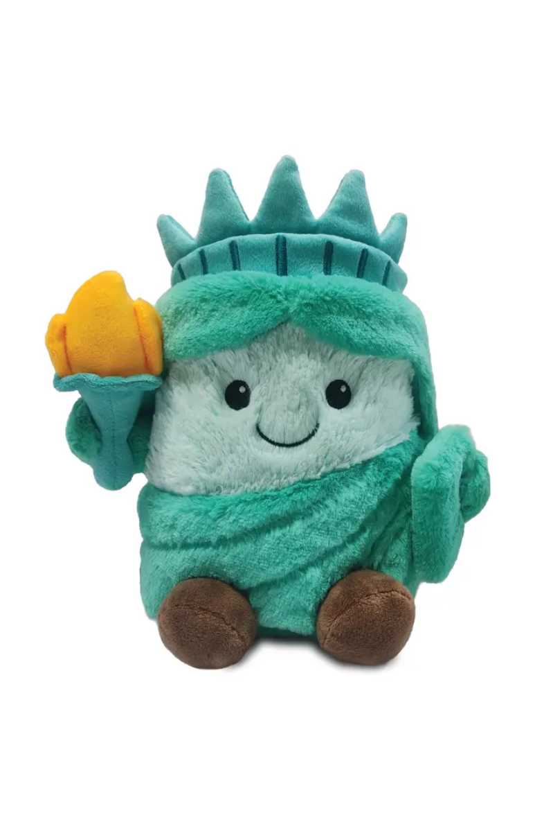 Toy resembling the Statue of Liberty on a white background