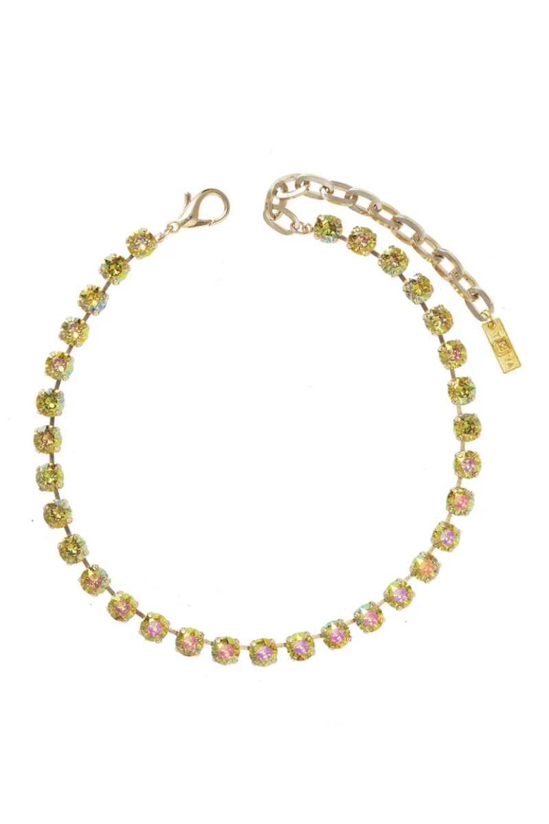 Gold necklace with colorful stones on a white background