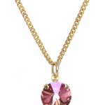 Gold necklace with a pink gemstone pendant on a white background