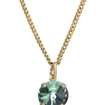 Gold necklace with a green gemstone pendant on a white background