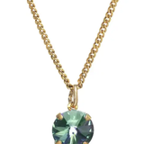 Gold necklace with a green gemstone pendant on a white background