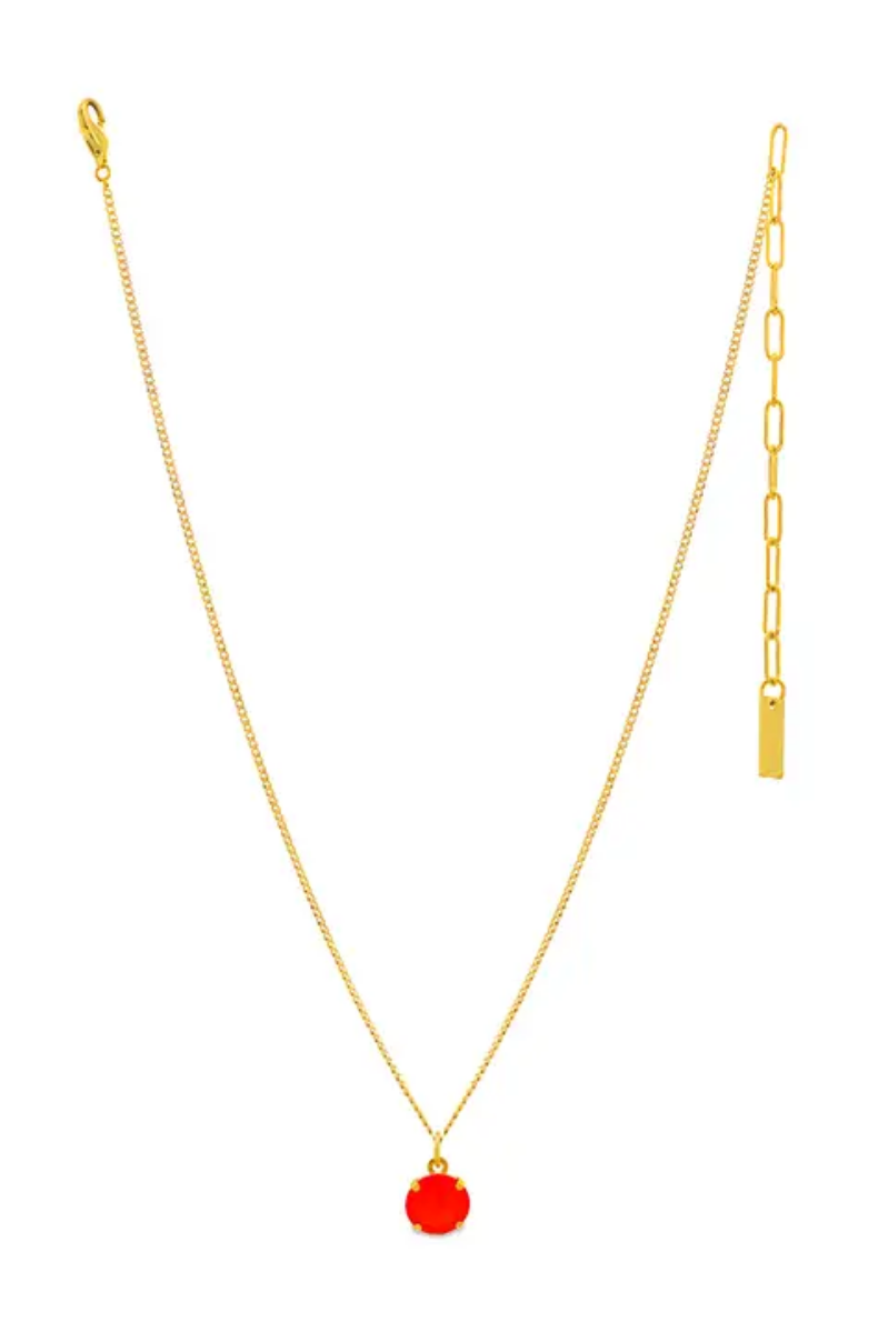 Gold necklace with a red pendant on a white background