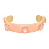Pink bracelet with gold accents on a white background