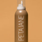Petajane tanning mousse bottle on a beige background in medium