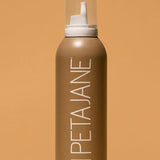 Petajane tanning mousse bottle on a beige background in medium