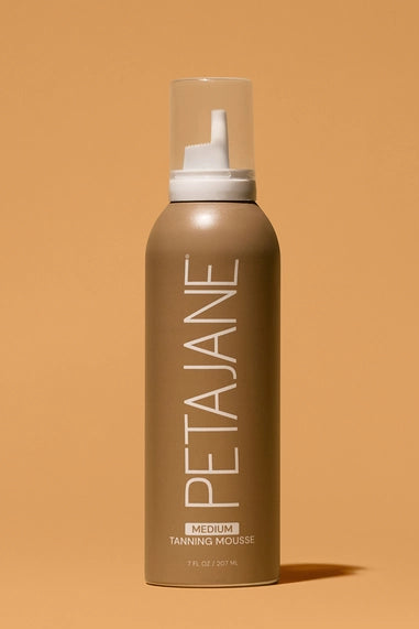 Petajane tanning mousse bottle on a beige background in medium