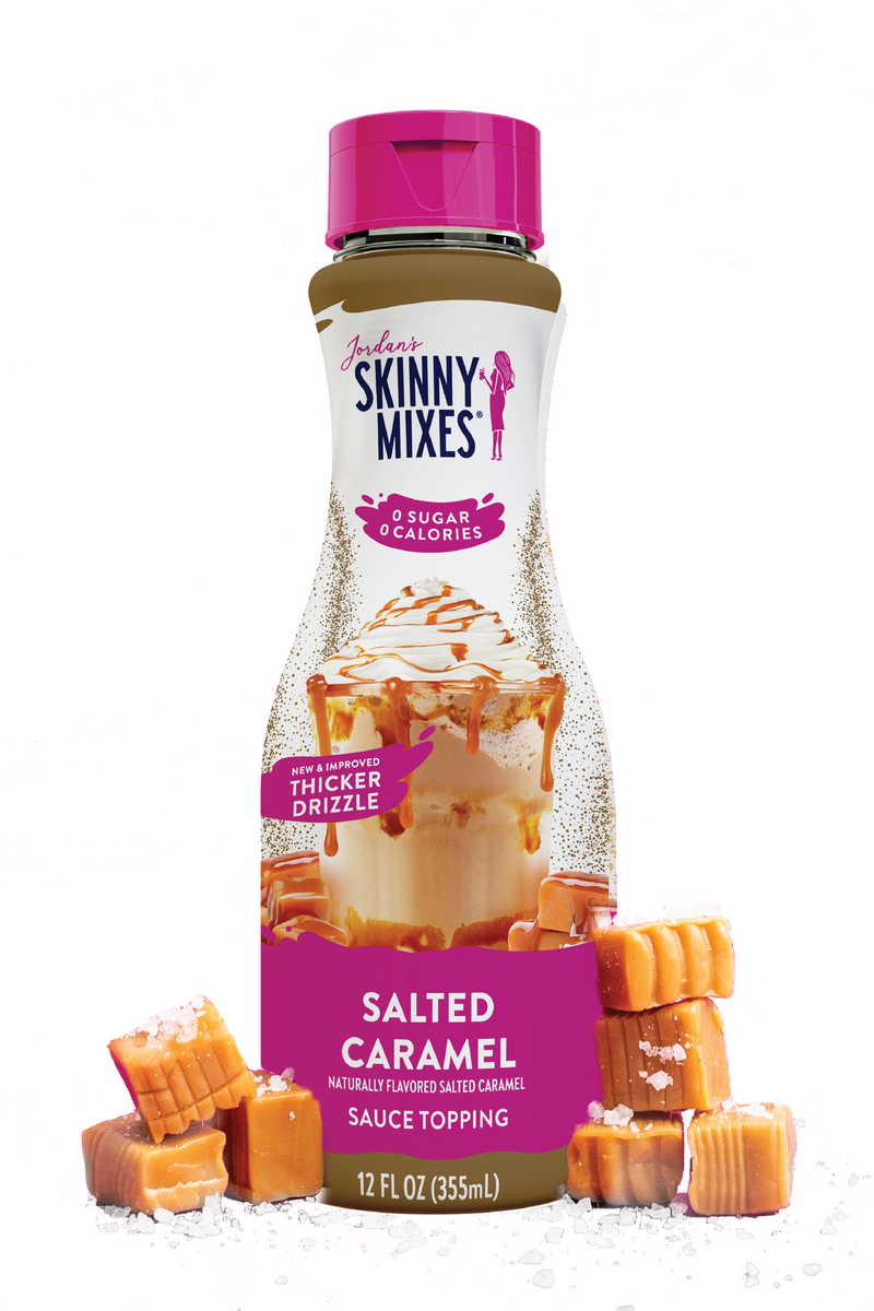 Bottle of Skinny Mixes Salted Caramel sauce with packaging and caramel candies on a white background