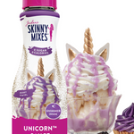 Skinny Mixes Unicorn sauce bottle with dessert items on a white background