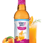 Skinny Mixes peach syrup bottle with a glass of peach juice and peaches on a white background