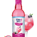 Skinny Mixes Dragon Fruit Acai syrup bottle with a glass of pink drink and dragon fruit slices on a white background