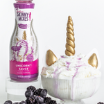 Unicorn-themed dessert with Skinny Mixes unicorn sauce bottle on a white background