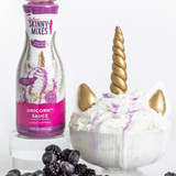 Unicorn-themed dessert with Skinny Mixes unicorn sauce bottle on a white background
