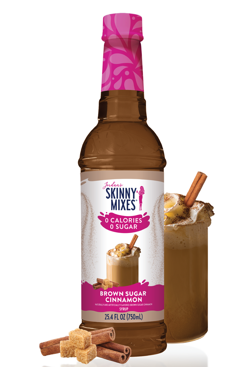 Bottle of Skinny Mixes Brown Sugar Cinnamon syrup with a glass of coffee and cinnamon sticks on a white background