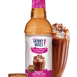 Skinny Mixes Peanut Butter Cup syrup bottle with a glass of dessert and smaller cups on a white background
