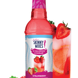 Bottle of Skinny Mixes strawberry syrup with a glass of strawberry drink and strawberries on a white background