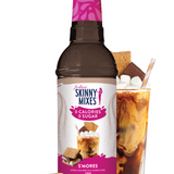 Skinny Mixes S'mores syrup bottle with a glass of iced coffee and s'mores on a white background
