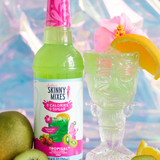 Bottle of Skinny Mixes Tropigenic drink with a glass, fruit, and colorful background